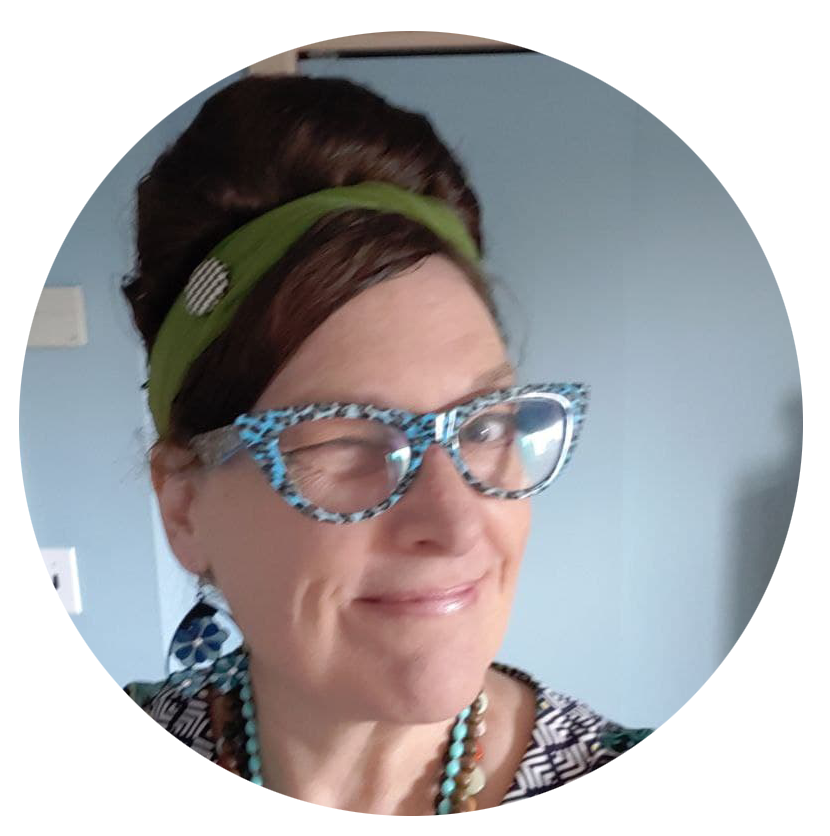 A portrait of Linda Unger looking at the camera, smiling and winking