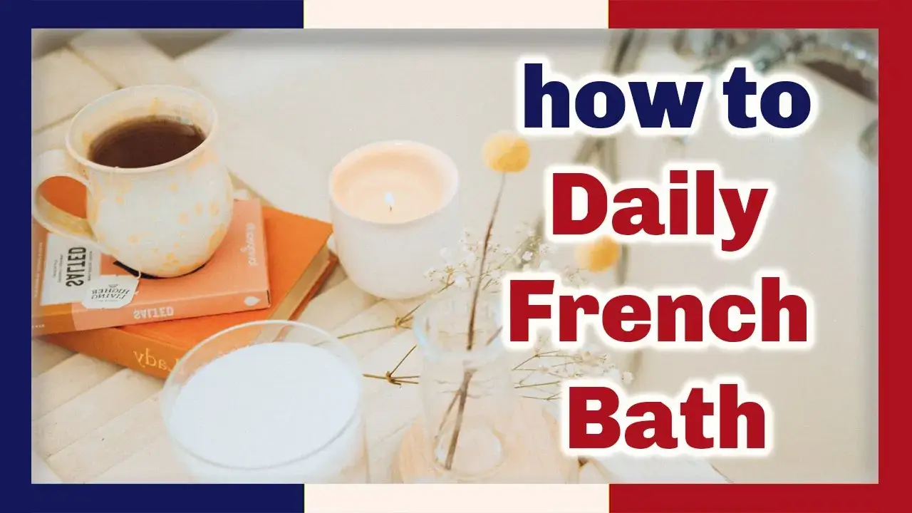 A cup of tea sits on two books on a tray with a glass of milk and a candle, and two pale orange flowers in a vase.  The words how to Daily French Bath at right in blue and red outlined in white